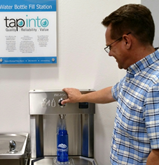 Water bottle fill station in use. 