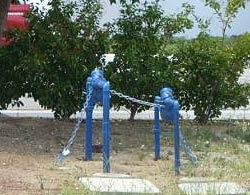 Blue metal backflow device with chained controls. 