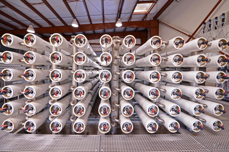 Desalination equipment stacked in a warehouse.
