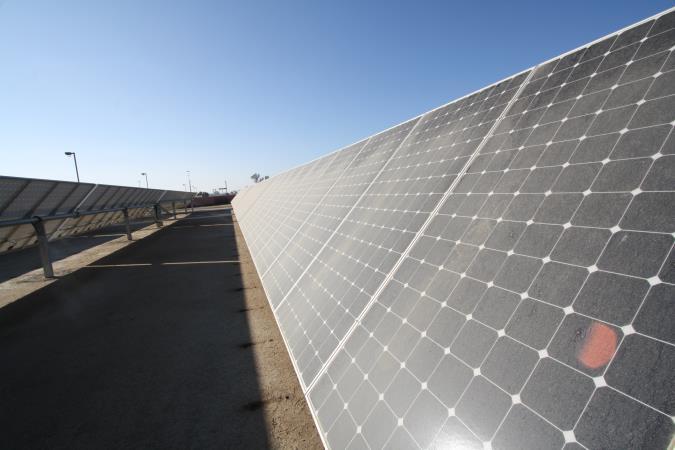 Solar panels in desert setting.